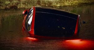 Vehicle crash submerged in a retention pond